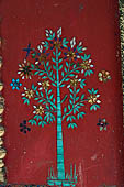 Luang Prabang, Laos - Wat Khili, on the side of the entrance the sim is decorated with glass mosaics of trees.